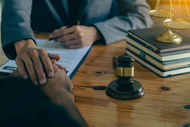 lawyer comforting grieving client, wrongful death case