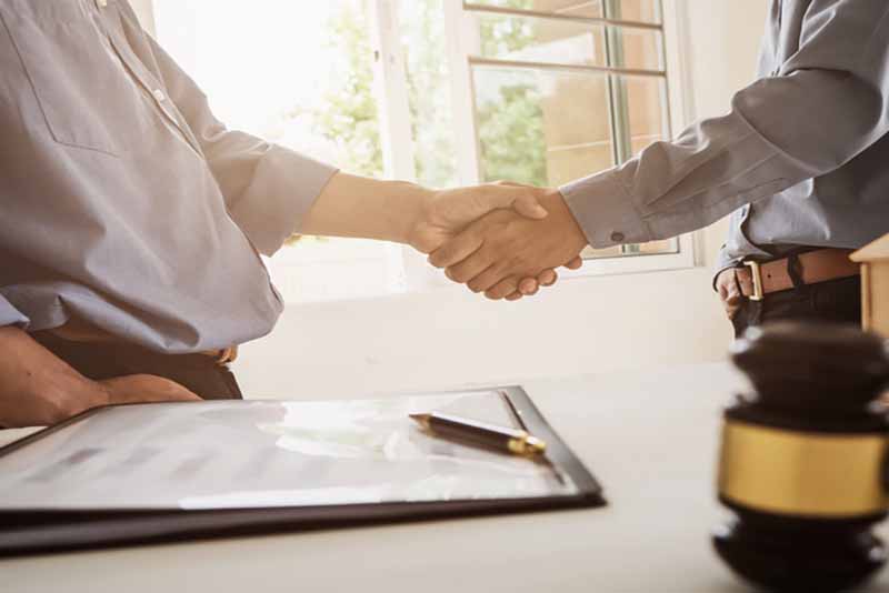 Lawyer and client shaking hands