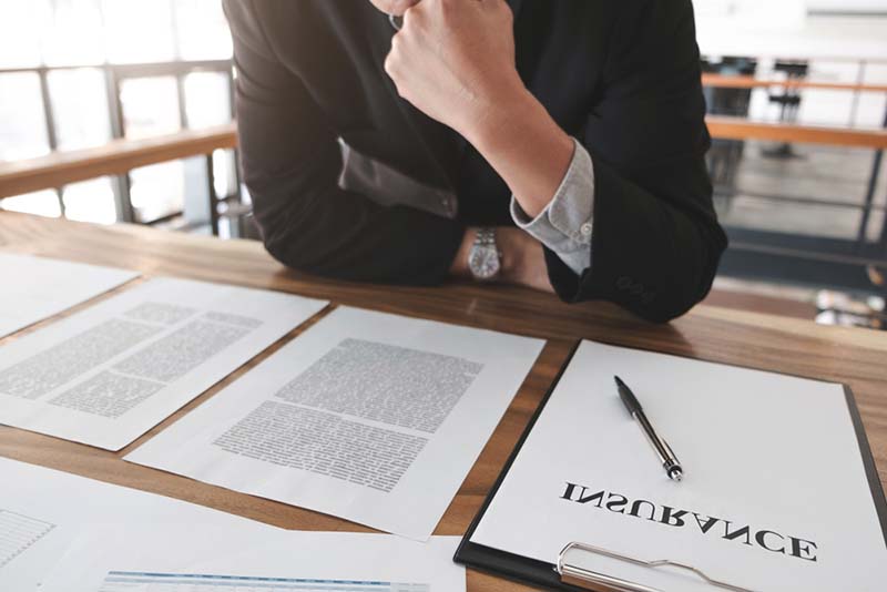 insurance policy lawyer reading insurance policy