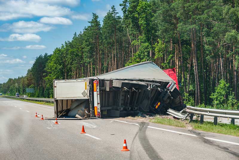 rolled over big rig at the side of the road