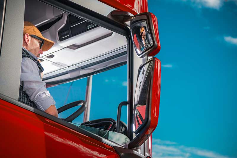 driver in a big red truck