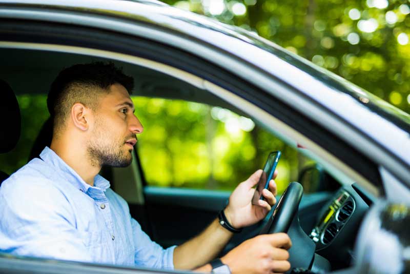 driver looking at his phone